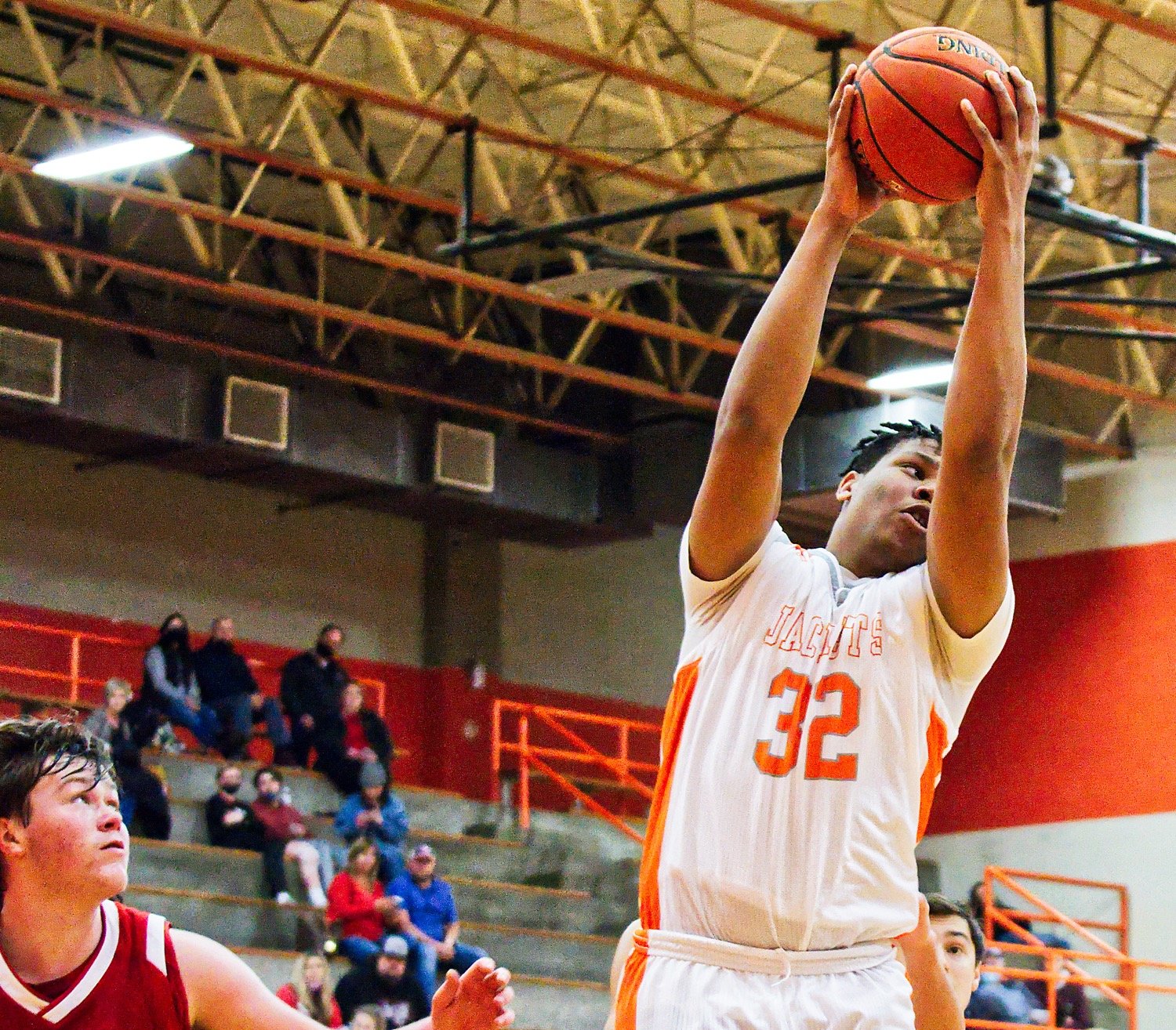 Stephen Ogueri (32) snags the rebound for Mineola in the Yellow jackets’ 100-36 win over Harmony.